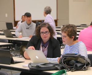 A Field Team member assists a retiree at an Office 365 migration event.