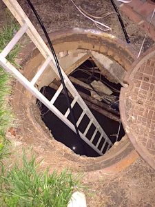 Ladder down into manhole for fiber installation 