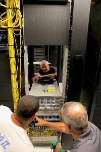 ITS Infrastructure & Operations employees rack the new Cisco Nexus at ITS Franklin.