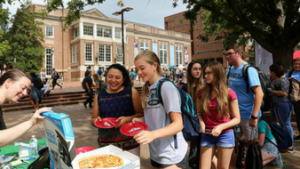 Students line up for pizza at the Tech Fair.