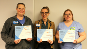 Three attendees of the February 2018 "Most" Lunch pose with their certificates.