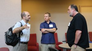 BarCamp participants, including CTC Advisory Board President Bil Hays, far right, talk before joining a break-out session