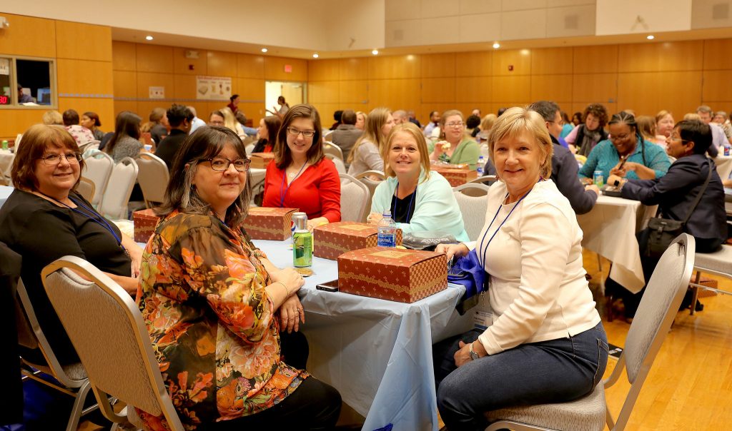 Five woman pose during lunch at the User Conference