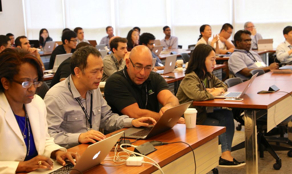 Participants learn in the lab portion of the Deep Learning Symposium