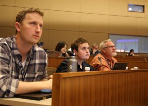 Karl Eklund, Tucker McGuire and Tim McGuire listen to a presentation at the Deep Learning event