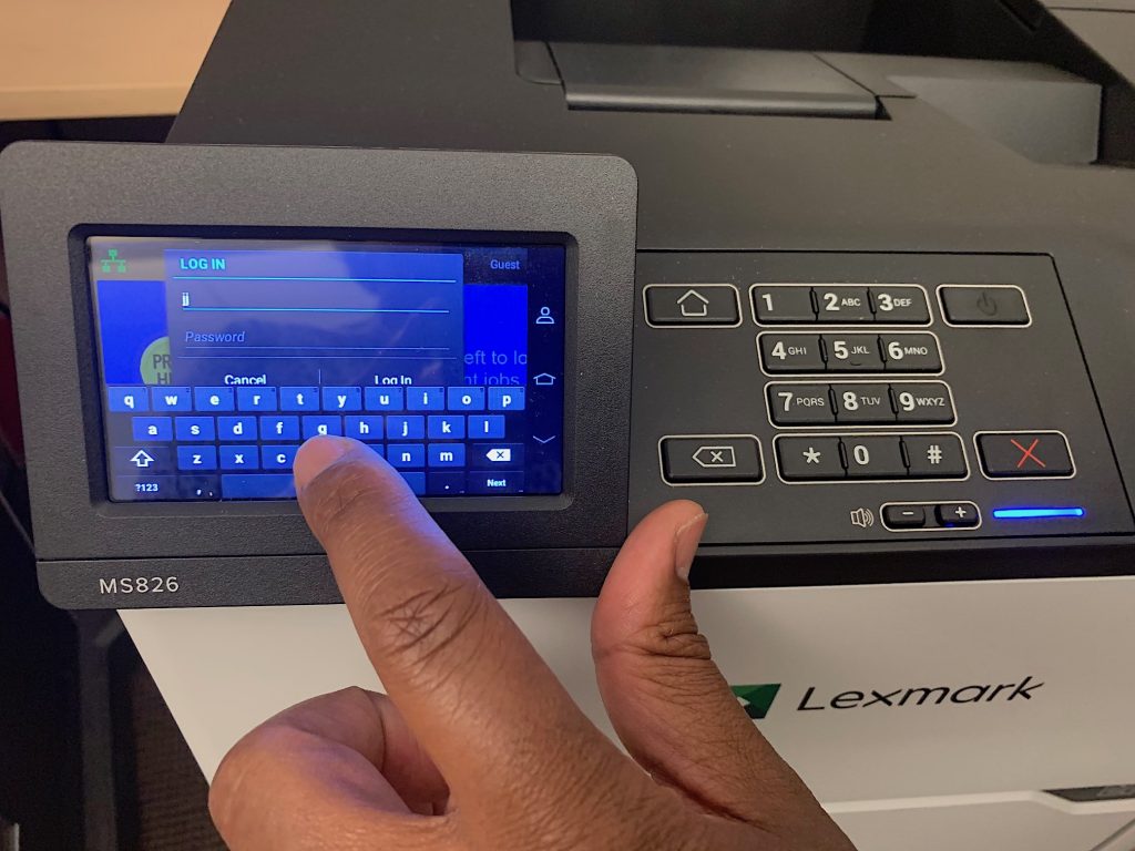Closeup of hand on touchscreen portion of printer