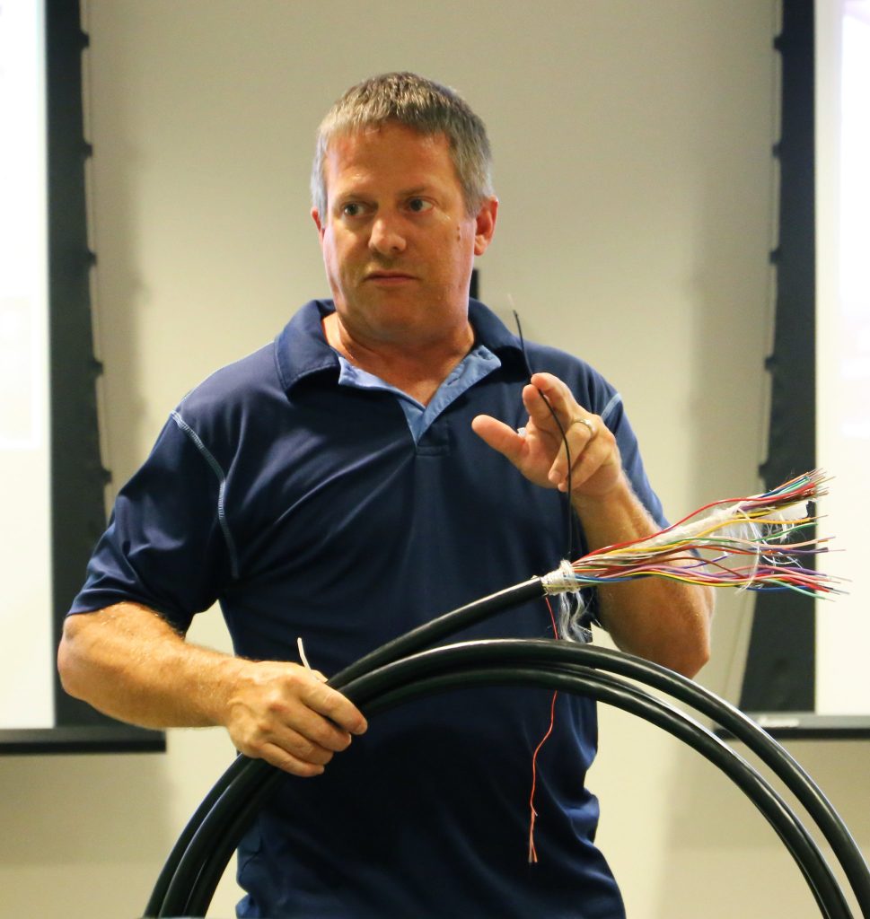 Chad Ray holds a cable of fiber