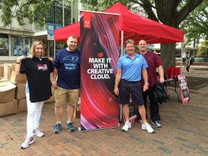 Greg Neville and Mike Roberts, then with Software Acquisition, pose with the Adobe reps at the 2016 Adobe Red Tent DayTent