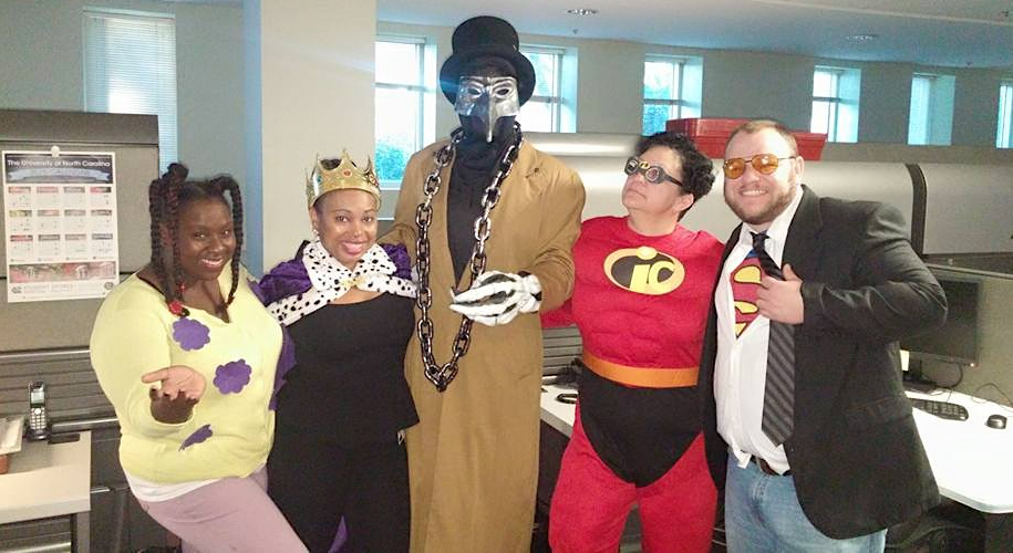 Ingrid Camacho and four Service Desk staffers wear costumes during Halloween years ago
