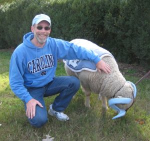 Mike Waldron, decked out in Carolina gear, pets the live Rameses mascot
