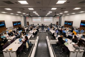 Overhead shot of Carroll 111, a new general purpose classroom loaded with technology, including six large screens