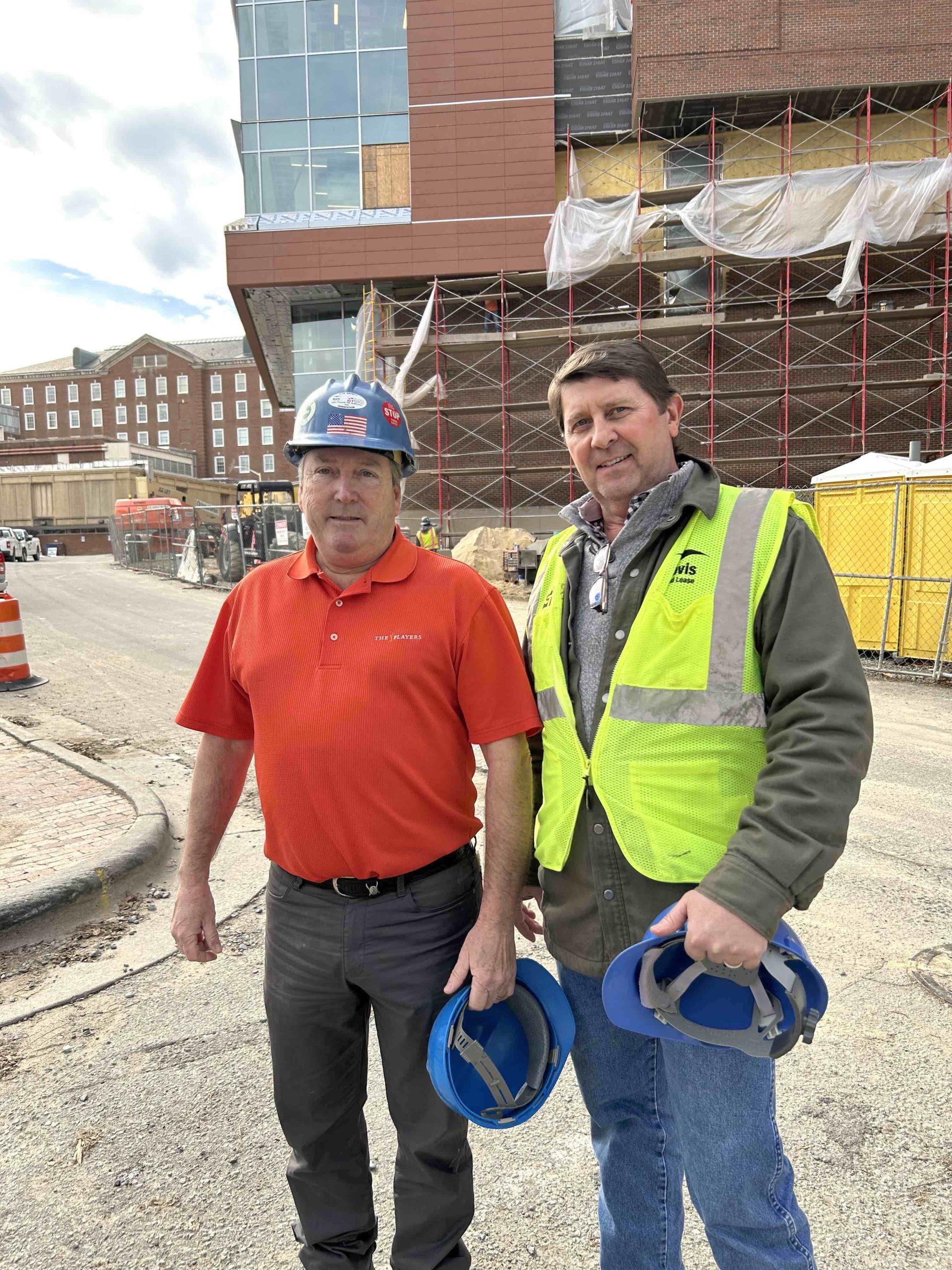 Frank Hall and Chuck Reese stand in front of the Roper Hall construction site.