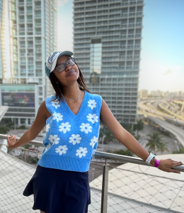 Jessica Walker stands in front of skyscraper buildings in Miami.